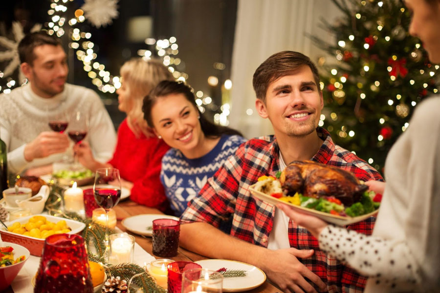 Photo of a family gathered around a table for a holiday dinner