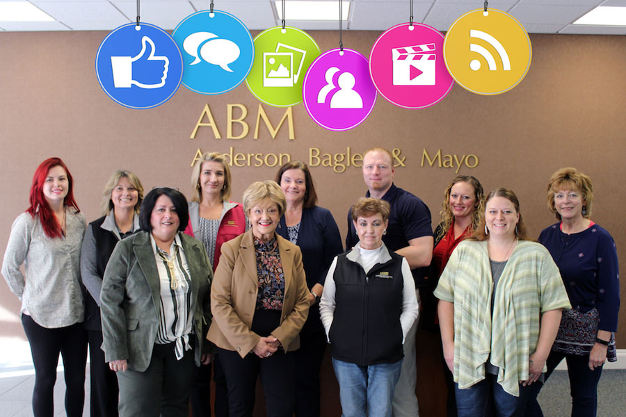Photo of the ABM team and family with social media icons