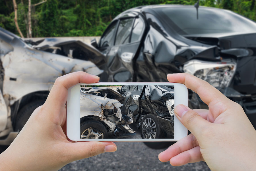 Photo of a person taking a picture of a car accident