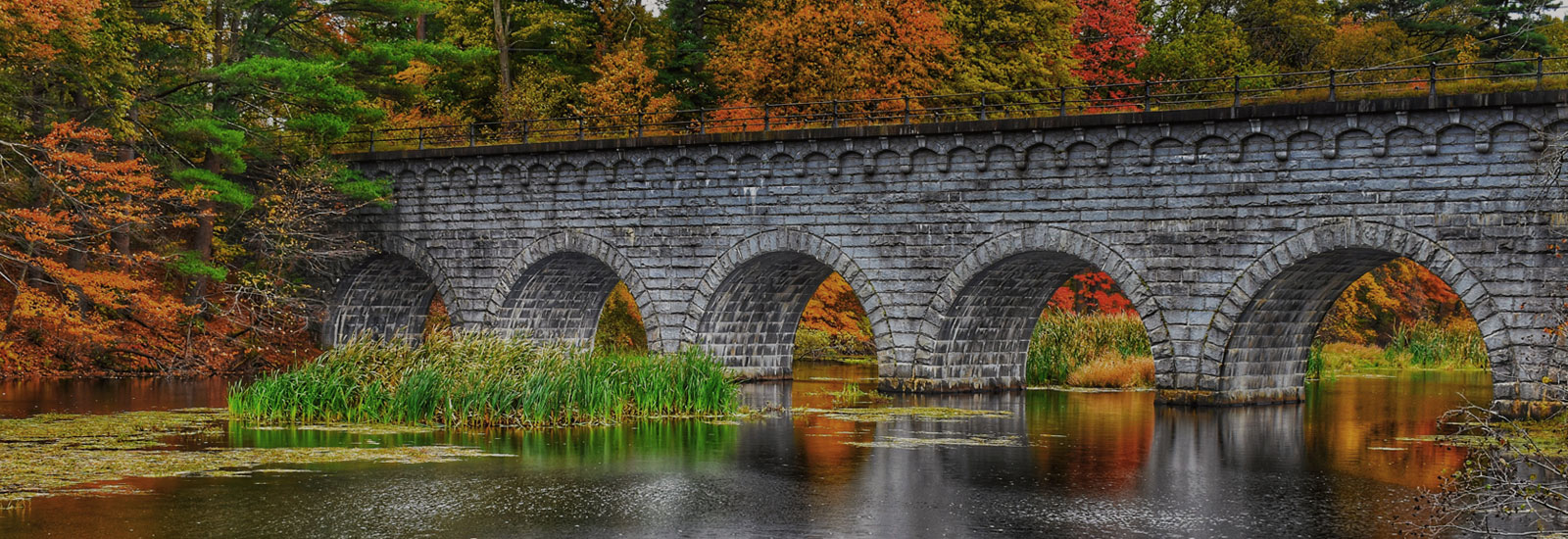 Photo of old bridge and water during the fall