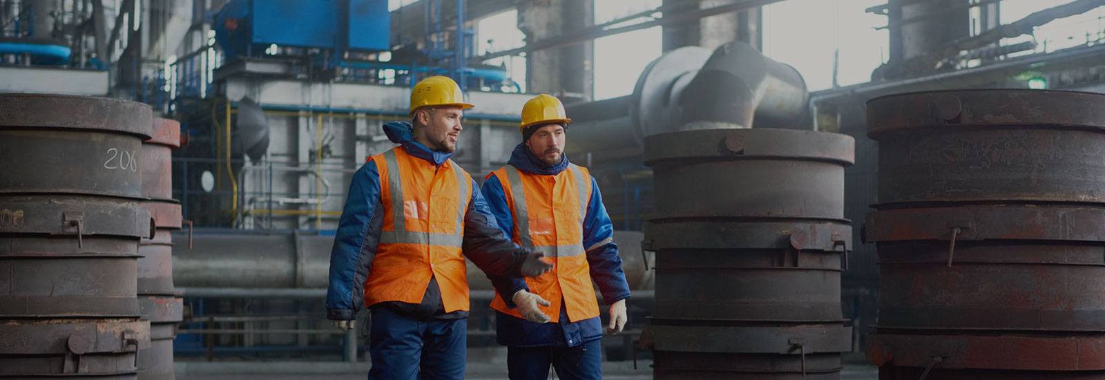 Photo of two construction workers wearing hard hats