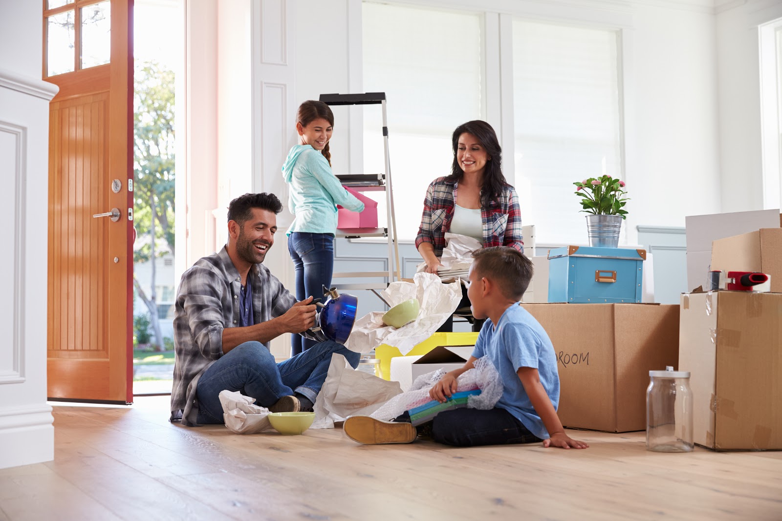 Photo of family unpacking moving boxes